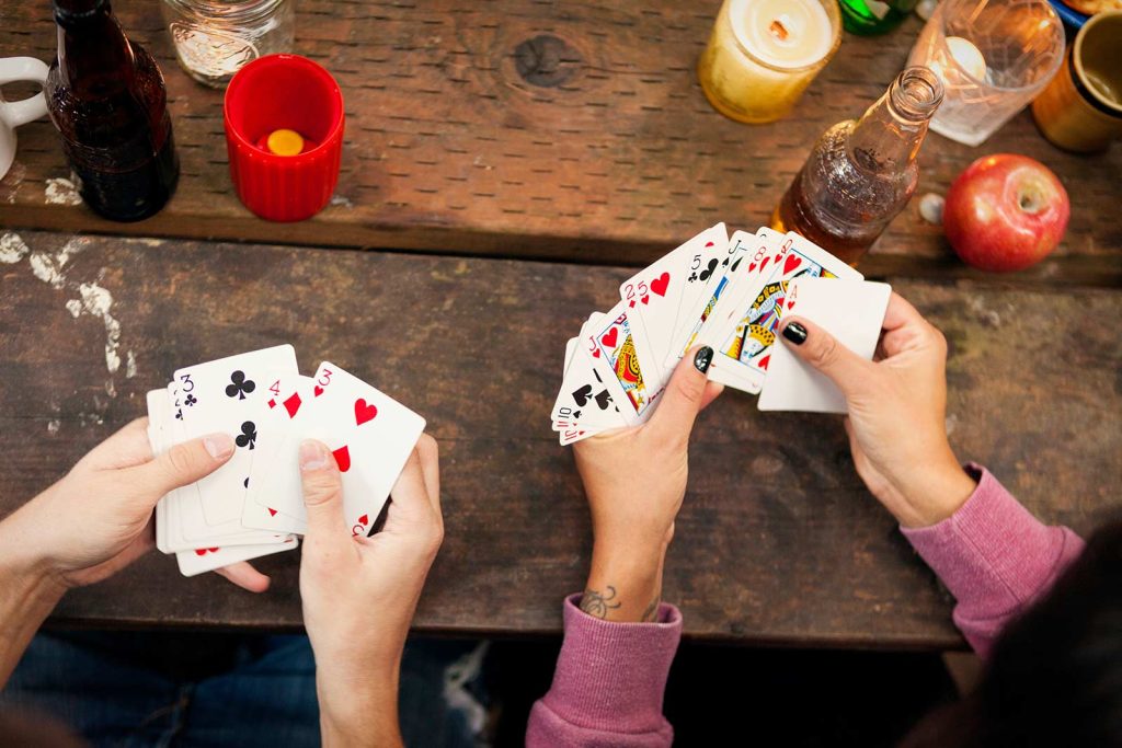 Friends playing cards and drinking beer